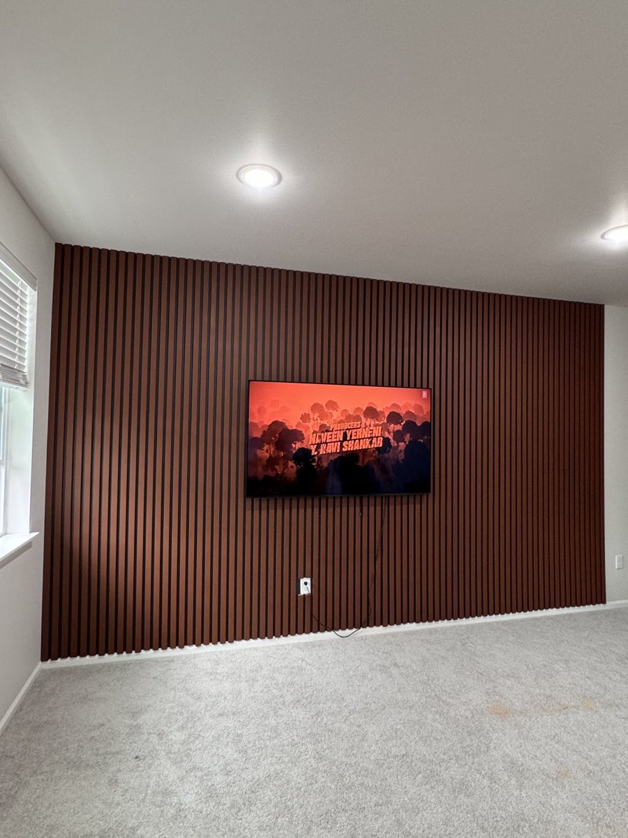 Finished walnut slat feature wall with mounted television
