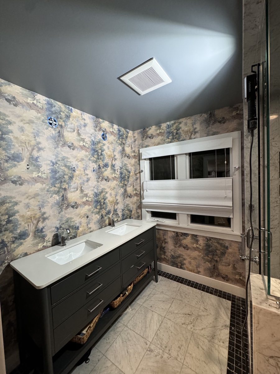 Soft botanical scenic wallpaper installed throughout a bathroom